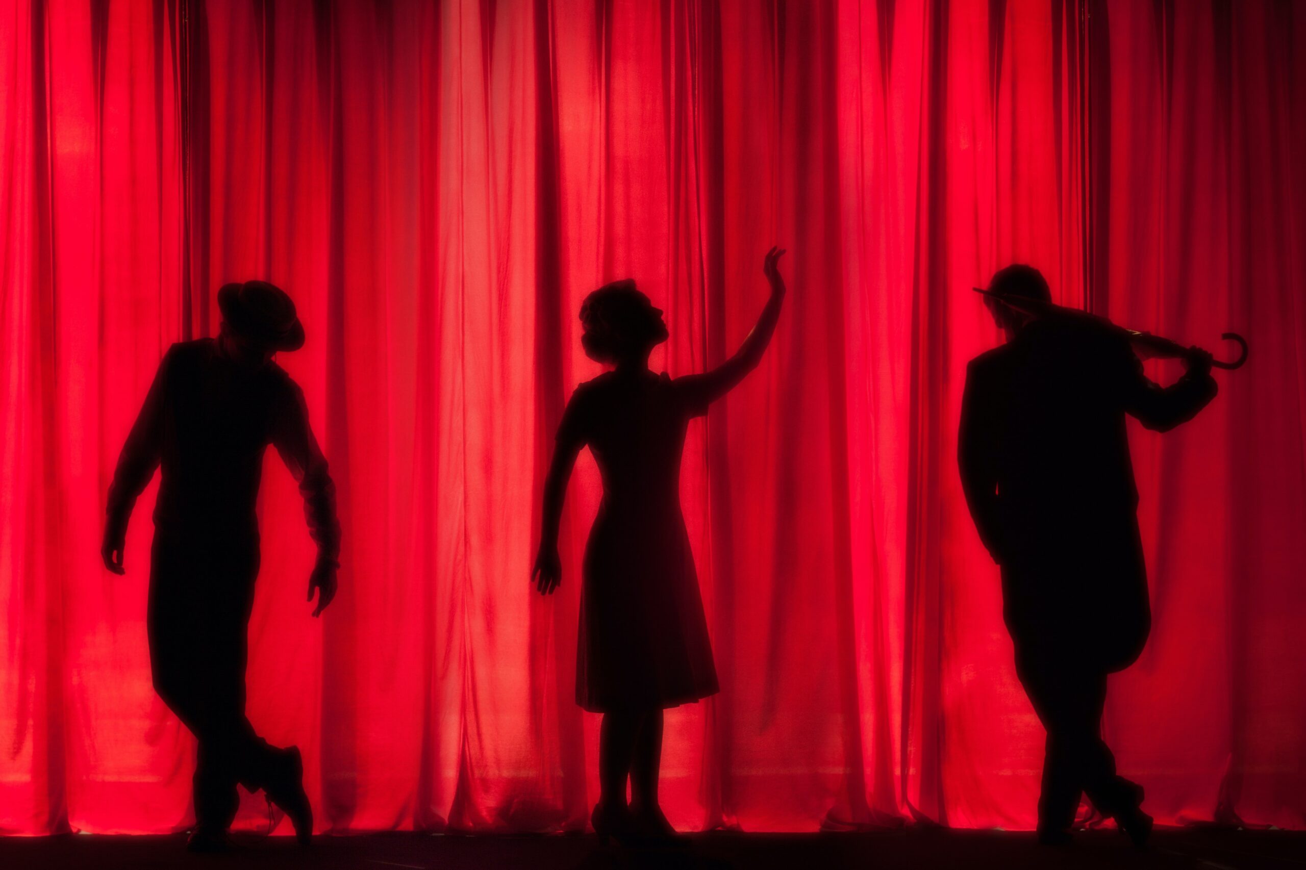 Silhouette of actors with red background