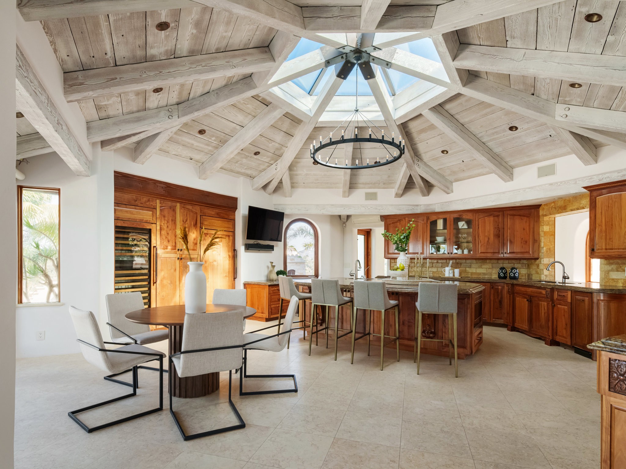 Stunning circular kitchen in a Coronado home with a skylight and open beam ceilings, embodying modern elegance and architectural beauty.