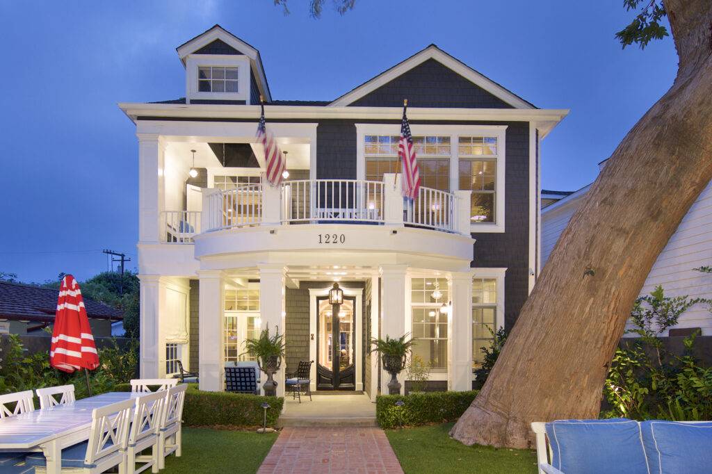 Coronado home for sale with stunning curb appeal, covered porch, and American flags