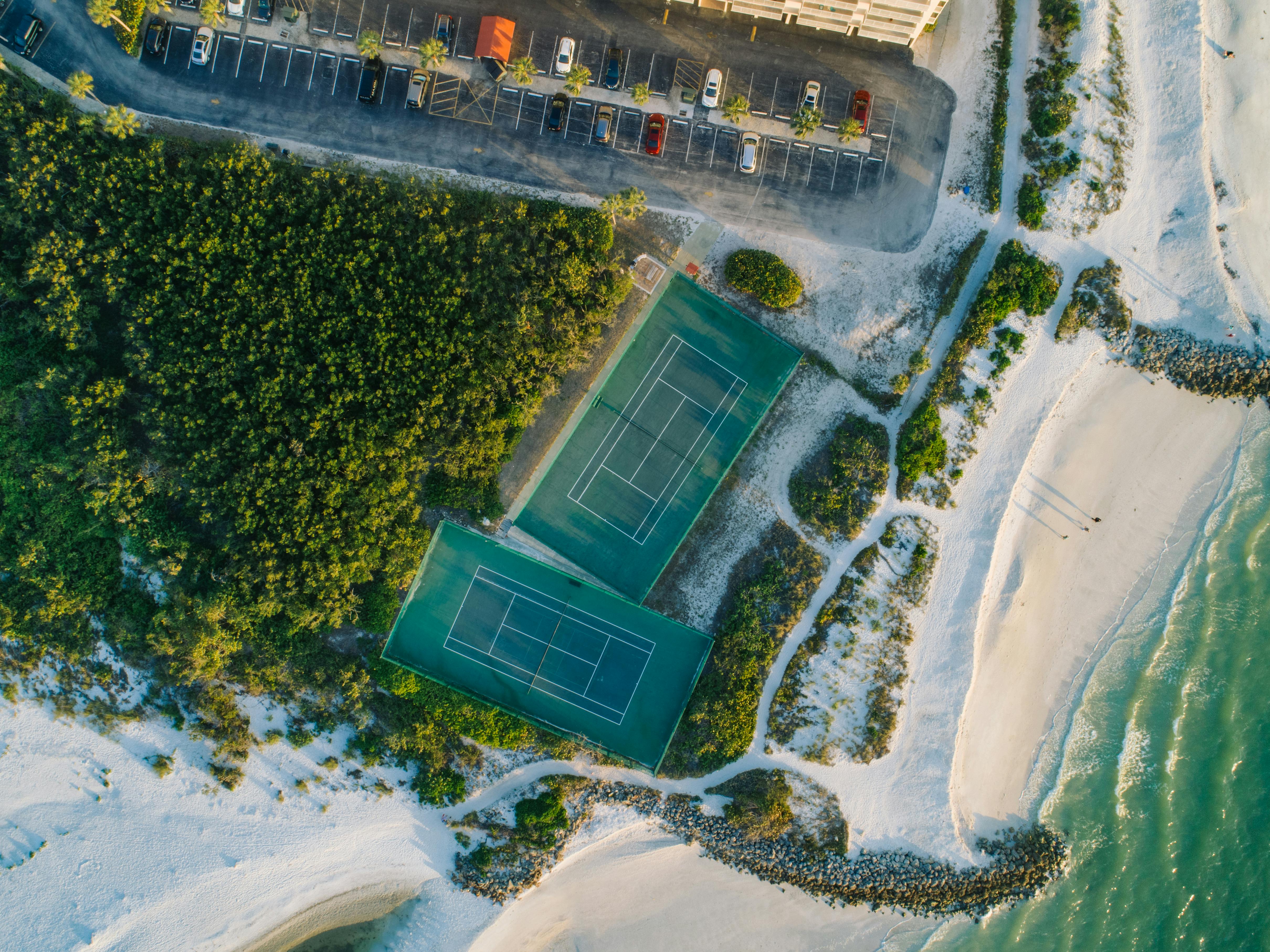 Aerial view of tennis courts next to the beach