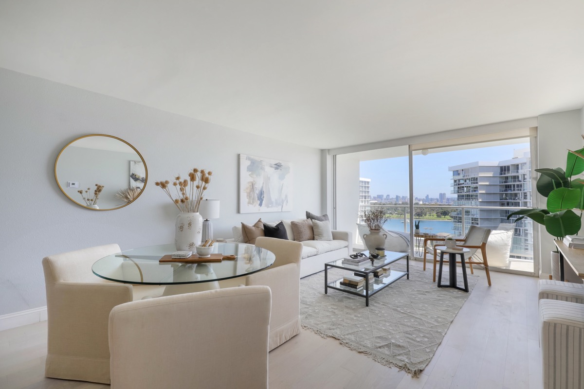 Living room of a Coronado Shores condo looking out to another building in the community where the top real estate agent and listing agent Whitney Benzian serves home sellers