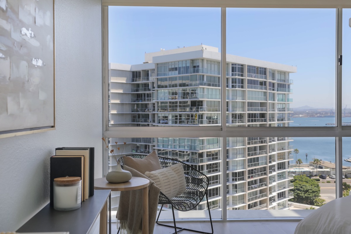 Looking out a window of a bedroom in a Coronado Shores condo for sale by the best Realtor Whitney Benzian