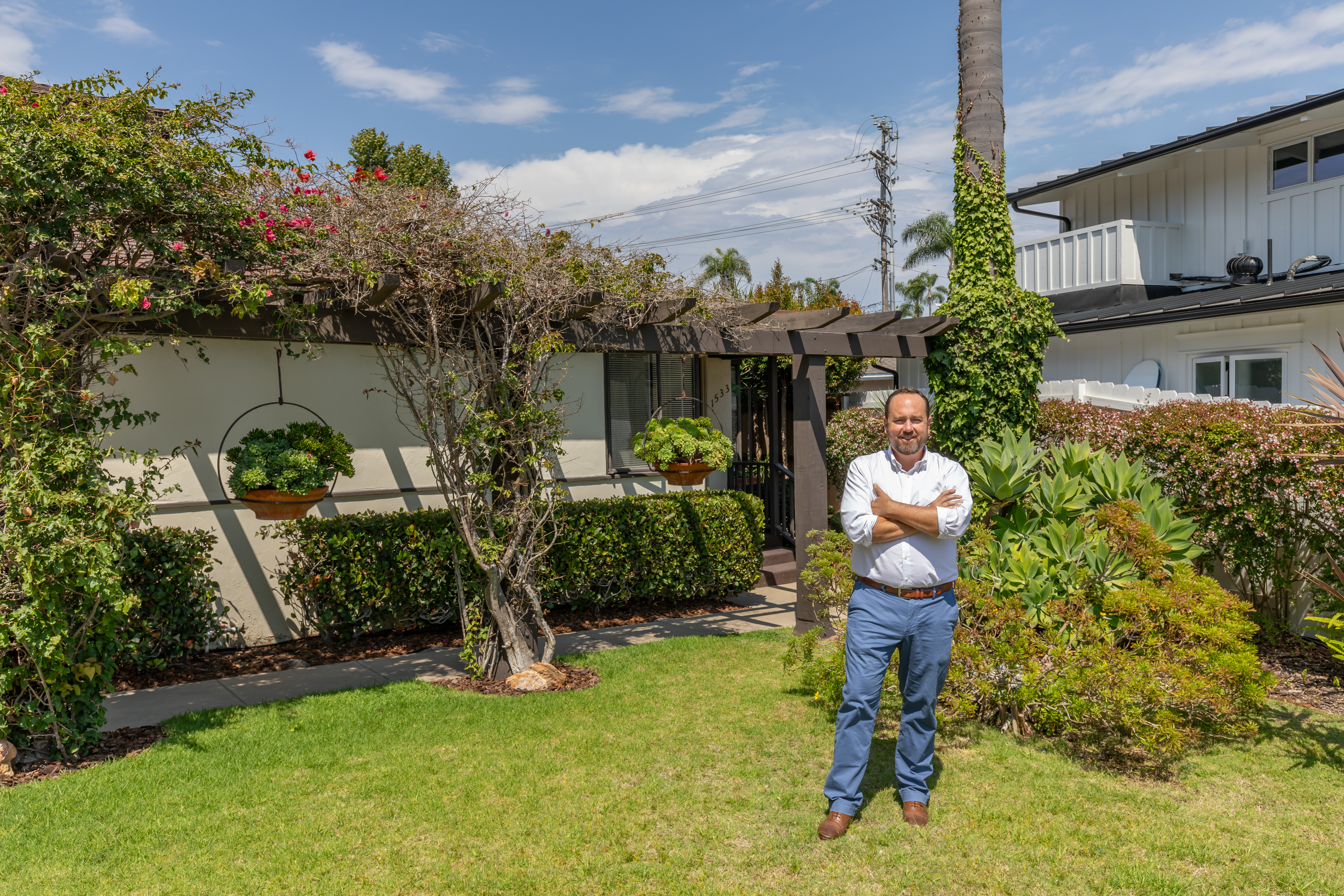 Top Coronado real estate agent realtor Whitney Benzian in dog friendly backyard