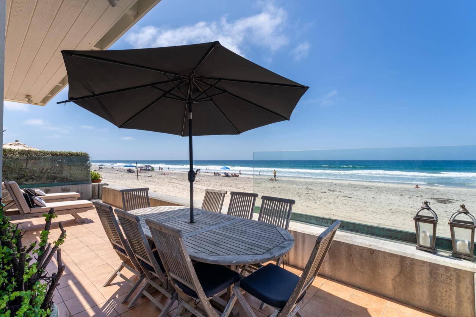 Beachfront property with patio by the sand and ocean waves, sold by the best Coronado Realtor Whitney Benzian